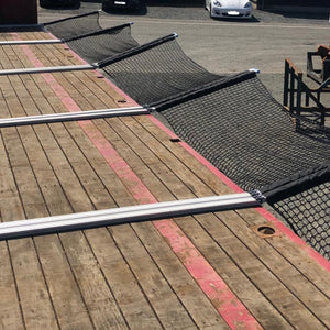 Customer photo of bespoke heavy duty cargo nets on the side of a vehicle trailer.