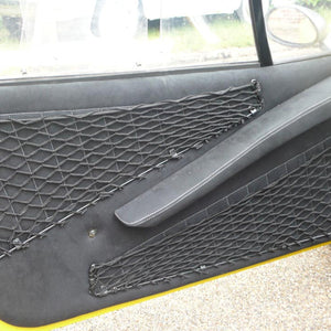 Bespoke frame elastic nets shaped to provide custom storage space inside a car door (customer photo).