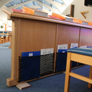 Bespoke elastic nets for organisation of books and music in a Church (customer photo).