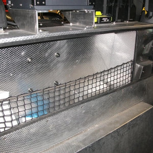 A bespoke non-elastic net with bungee around the edge to help keep items within the storage well in an emergency vehicle (customer photo).