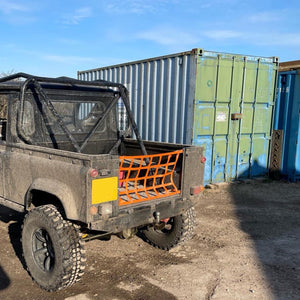Custom orange webbing cargo net to fit the back of a Land Rover (customer photo).