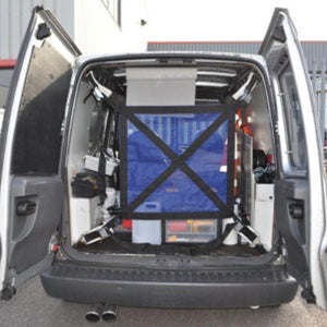 Load restraint net with ratchets fitted in the back of a vehicle.