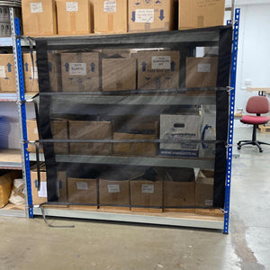 Load control net with integrated fittings across warehouse shelving.