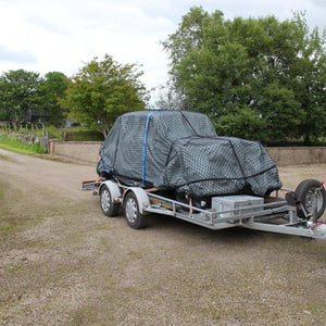 Bespoke load control net to cover a car on a trailer (customer photo).