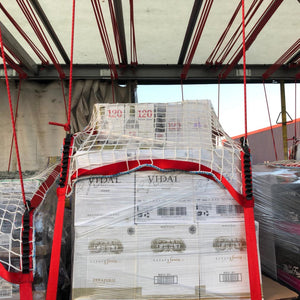 Load control nets with integrated fittings in use as part of a cargo load control system on a curtain side truck.