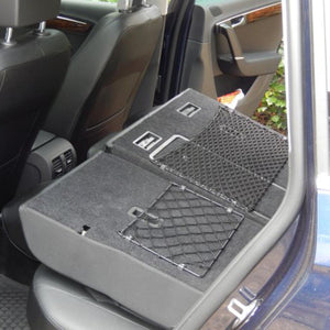 Custom-made frame elastic nets to create storage space behind the rear seats in a VW Passat (customer photo).