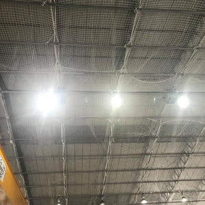 Safety netting under a roof inside a warehouse.