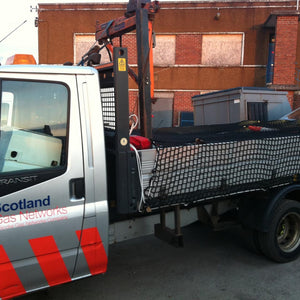 Cargo net covering a load on the back of a vehicle trailer (customer photo).
