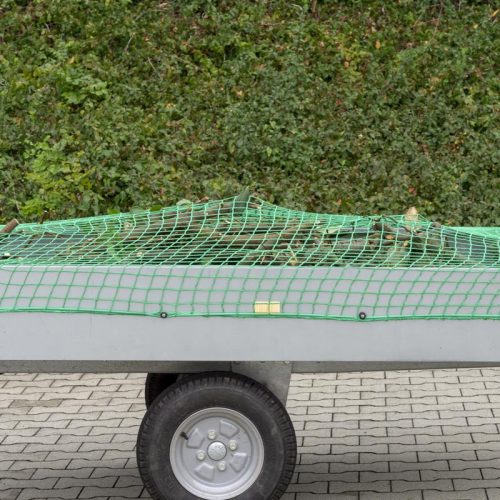 Cargo net covering sticks on trailer