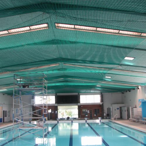 Safety nets under roof above swimming pool