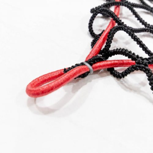 Black elastic net with red bungee - close up of corner loop