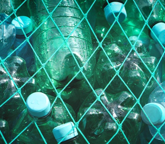 Green knotted net covering plastic bottles