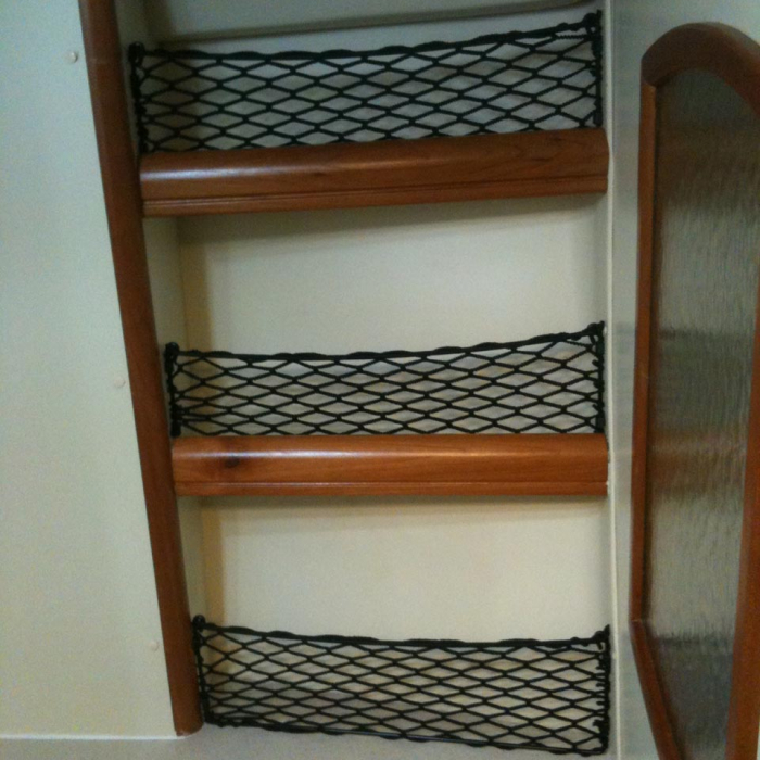 Custom frame elastic nets to fit in front of shelves in camper van