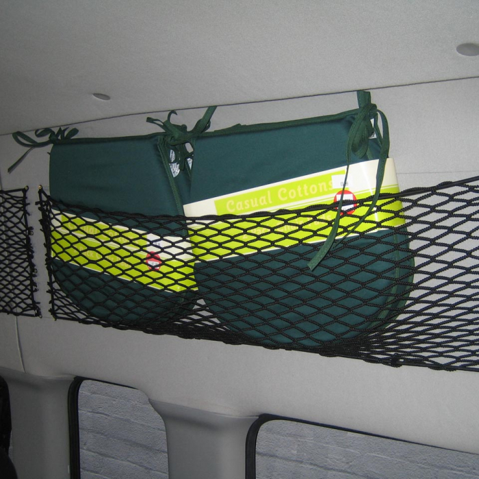 Bespoke elastic nets to create storage space on the inside of a van showing items within the net
