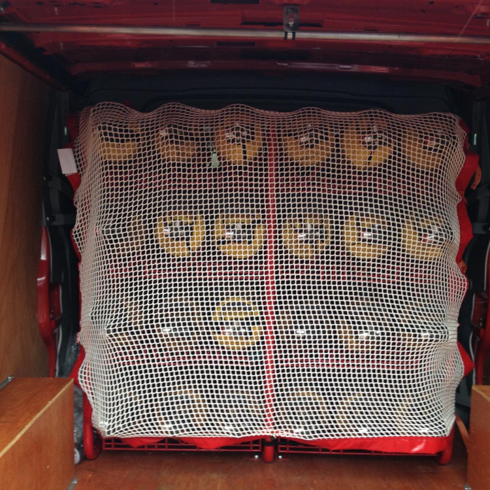 Bespoke load restraint cargo net to cover cylinders in the back of a commercial vehicle.