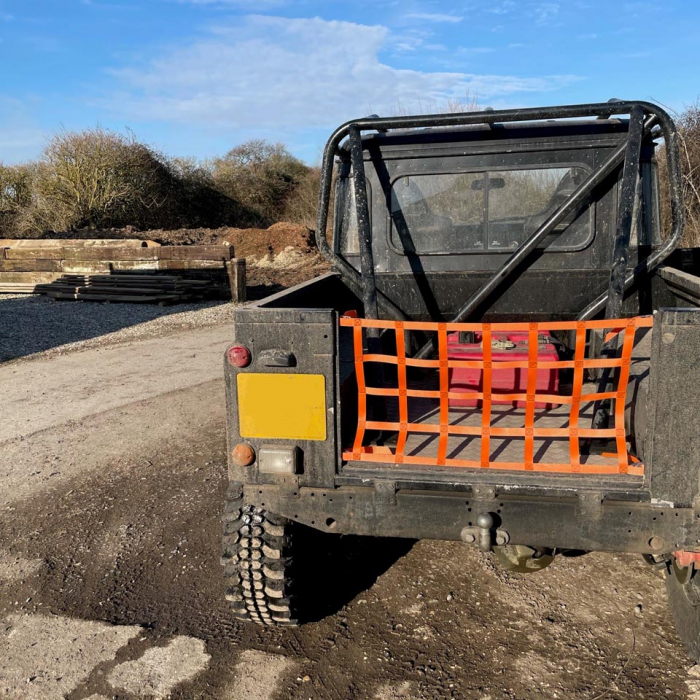 Custom orange webbing cargo net to fit the back of a Land Rover