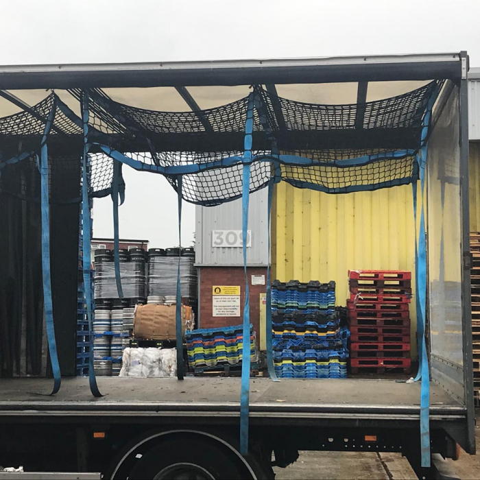 Load control nets with integrated fittings as part of a cargo load control system on a truck.