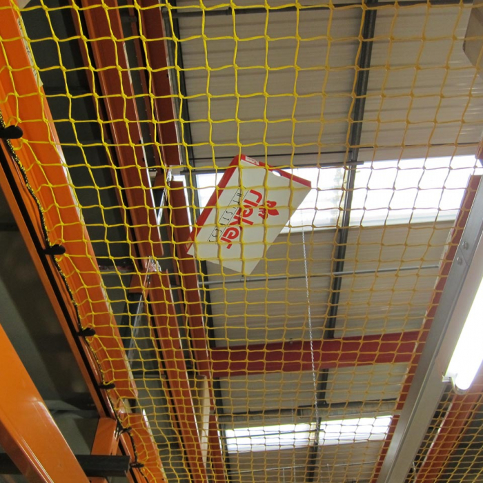 Yellow knotted netting in a warehouse.